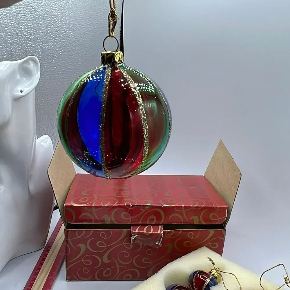 Vintage Avon 2001 Holiday Treasures blown glass ornaments.
